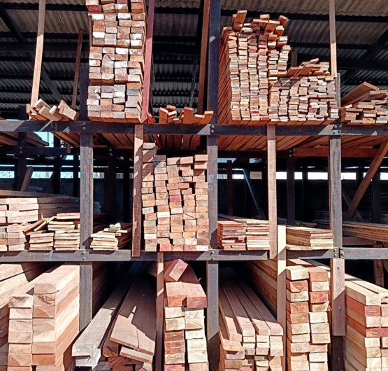 a pile of wood sitting inside of a building